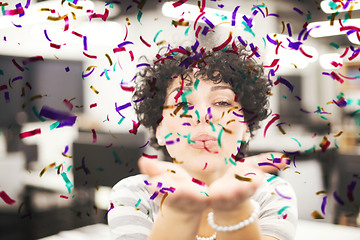 Image showing female software developer blowing confetti