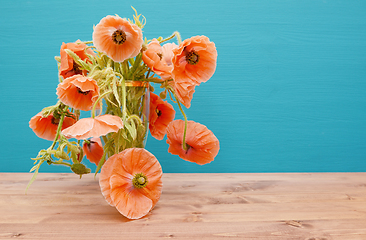 Image showing Numerous beautiful cut pink poppies with long winding stems