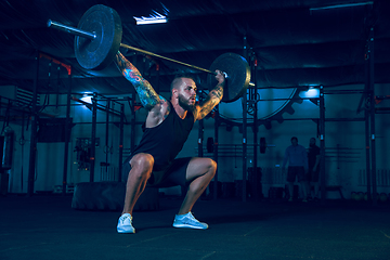 Image showing Young healthy man athlete doing exercise in the gym