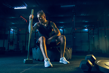 Image showing Young healthy man athlete doing exercise in the gym