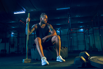 Image showing Young healthy man athlete doing exercise in the gym