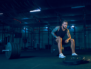 Image showing Young healthy man athlete preparing for training in the gym