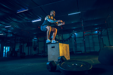 Image showing Young healthy man athlete doing exercise in the gym