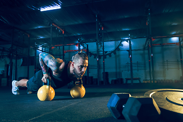 Image showing Young healthy man athlete doing exercise in the gym