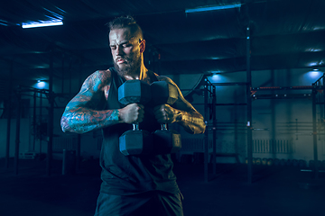 Image showing Young healthy man athlete doing exercise in the gym