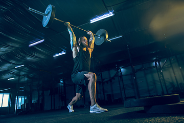 Image showing Young healthy man athlete doing exercise in the gym