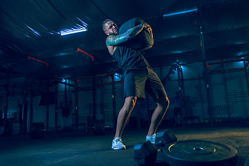 Image showing Young healthy man athlete doing exercise in the gym