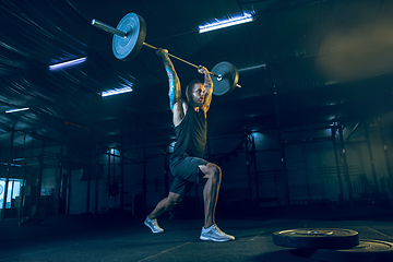 Image showing Young healthy man athlete doing exercise in the gym