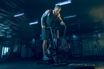 Image showing Young healthy man athlete doing exercise in the gym