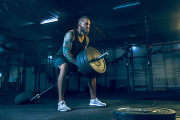 Image showing Young healthy man athlete doing exercise in the gym