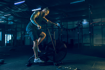 Image showing Young healthy man athlete doing exercise in the gym