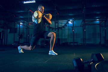 Image showing Young healthy man athlete doing exercise in the gym