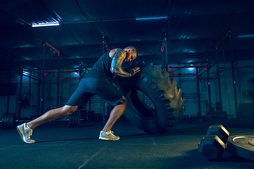 Image showing Young healthy man athlete doing exercise in the gym