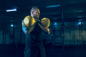 Image showing Young healthy man athlete doing exercise in the gym