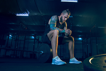 Image showing Young healthy man athlete preparing for training in the gym