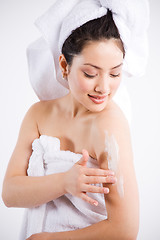 Image showing Beautiful asian spa woman and lotion