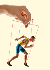 Image showing Man like a puppet in somebodies hands. Concept of manipulation