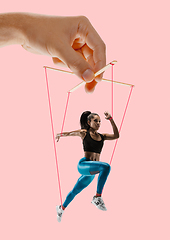 Image showing Woman like a puppet in somebodies hands. Concept of manipulation