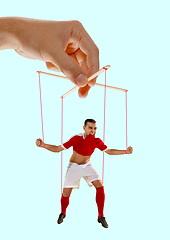 Image showing Man like a puppet in somebodies hands. Concept of manipulation