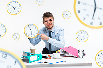 Image showing Young man can\'t wait to go home from the nasty office