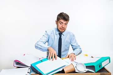 Image showing The young man has a complete mess in the workplace, he cannot organize his space