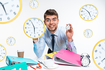 Image showing Young man can\'t wait to go home from the nasty office