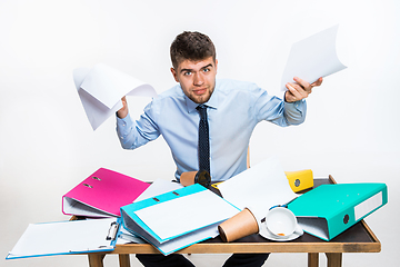 Image showing The young man has a complete mess in the workplace, he cannot organize his space