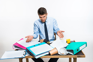 Image showing The young man has a complete mess in the workplace, he cannot organize his space