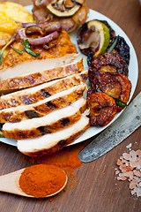 Image showing roasted grilled BBQ chicken breast with herbs and spices 