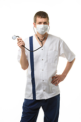 Image showing Doctor in mask laughs and twirls a phonendoscope in his hand, isolated on white background