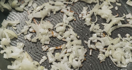 Image showing Preparing onions in frying pen closeup footage