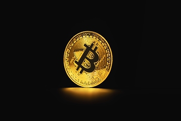 Image showing Physical shiny bitcoin agains dark background