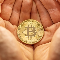 Image showing Physical bitcoin held in hands closeup