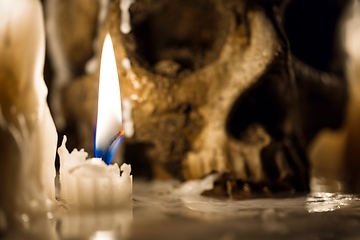 Image showing Human skull against dark background in candle light closeup