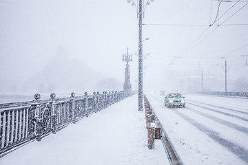 Image showing Traffic on snow covered bridge during heavy snow storm