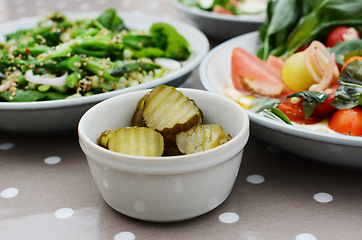 Image showing Tangy gherkin slices and fresh summer salads