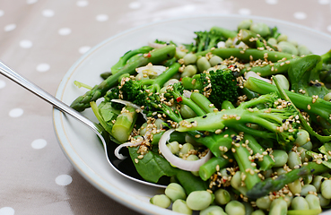 Image showing Serving spoon in a spring salad of broccolini and beans