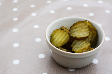 Image showing Slices of juicy, sour gherkins in a ceramic pot