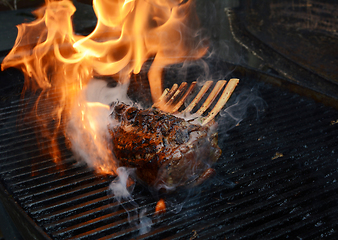 Image showing Tender rack of lamb being grilled on a barbecue