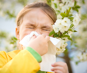 Image showing Little girl is blowing her nose