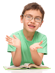 Image showing Little boy is reading a book