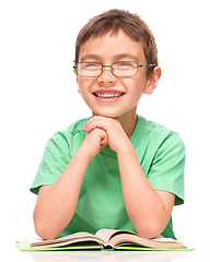 Image showing Little boy is reading a book