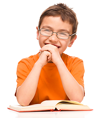 Image showing Little boy is reading a book