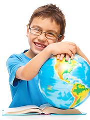 Image showing Little boy is holding globe