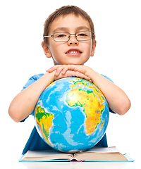 Image showing Little boy is holding globe