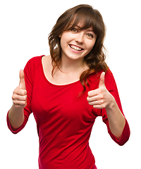 Image showing Woman is showing thumb up gesture