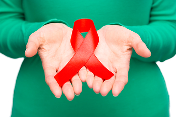 Image showing Woman is holding the red awareness ribbon