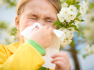 Image showing Little girl is blowing her nose