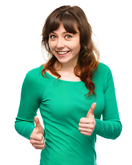 Image showing Woman is showing thumb up gesture