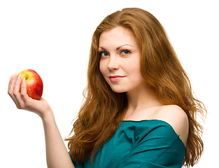 Image showing Young happy girl with apple